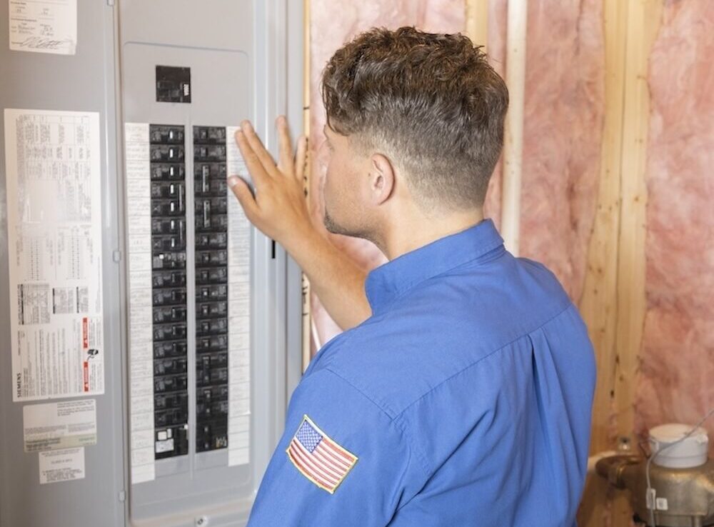 employee inspecting circuit breaker