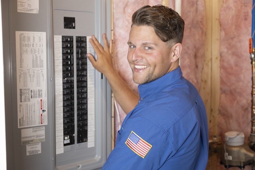 employee inspecting circuit breaker